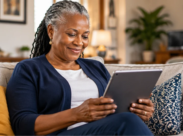 Illustration of a mature African woman reading a digital guide on a tablet at home